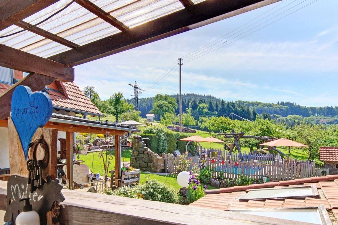 Blick auf Spielplatz und Naturpool von der Terrasse der Ferienwohnung Magaritte